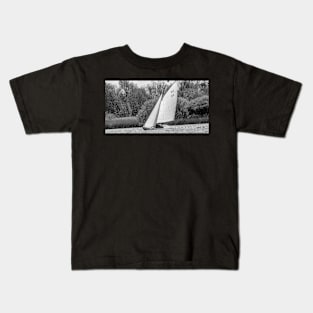 A lone brown boat sailing around Wroxham Broad, Norfolk Kids T-Shirt